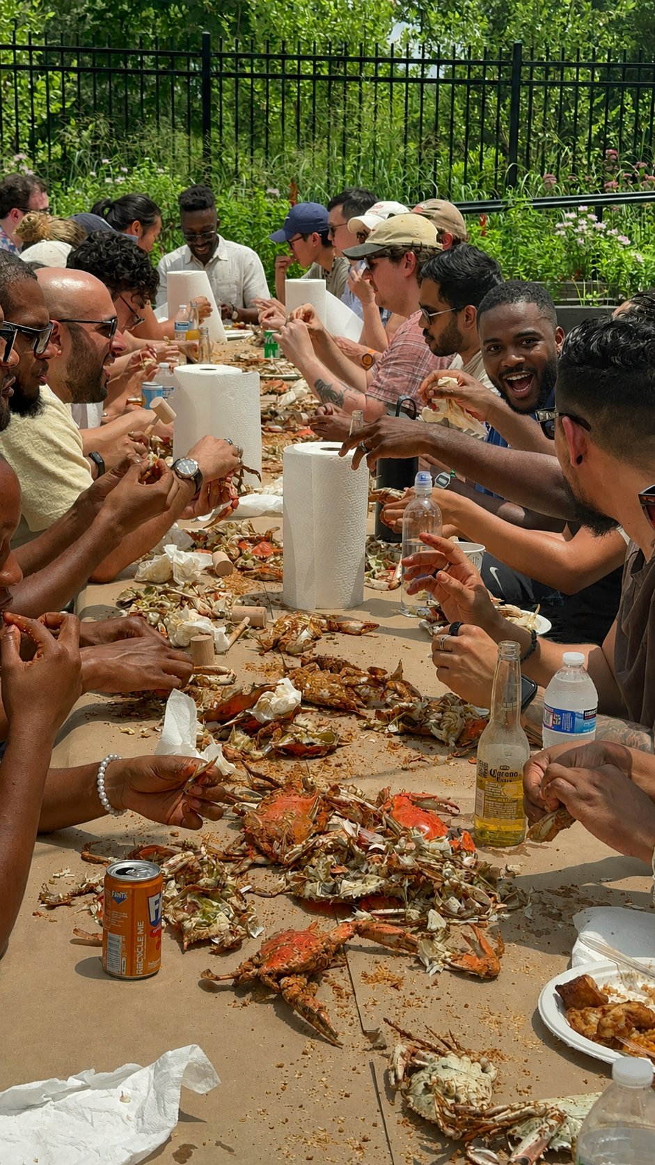 Friends sharing a crab feast at a long outdoor table