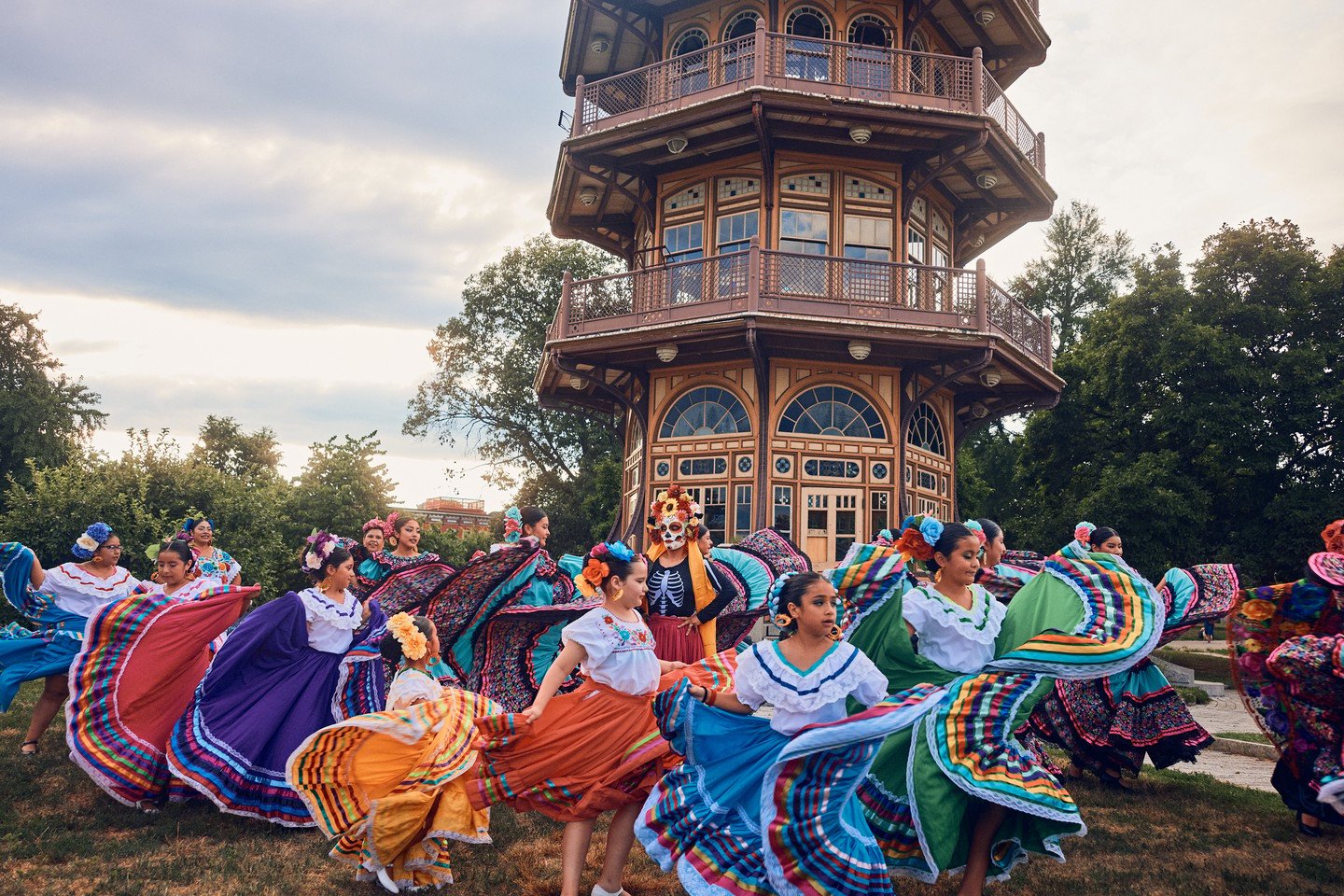 Dancers in colorful skirts in front of the Patterson Park Pagoda